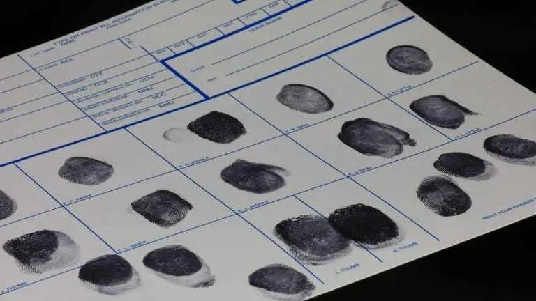 A fingerprint card filled with multiple rows of black ink fingerprints, displaying individual prints clearly for identification or background check purposes.
